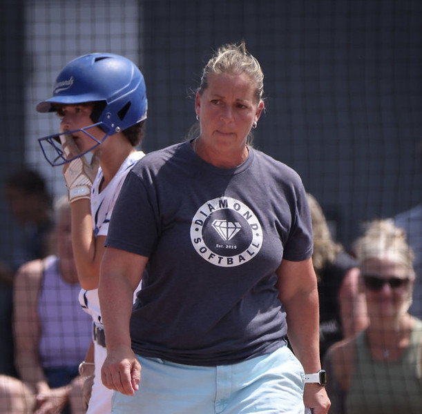 Diamond Softball Club coach checking in with a batter during a game