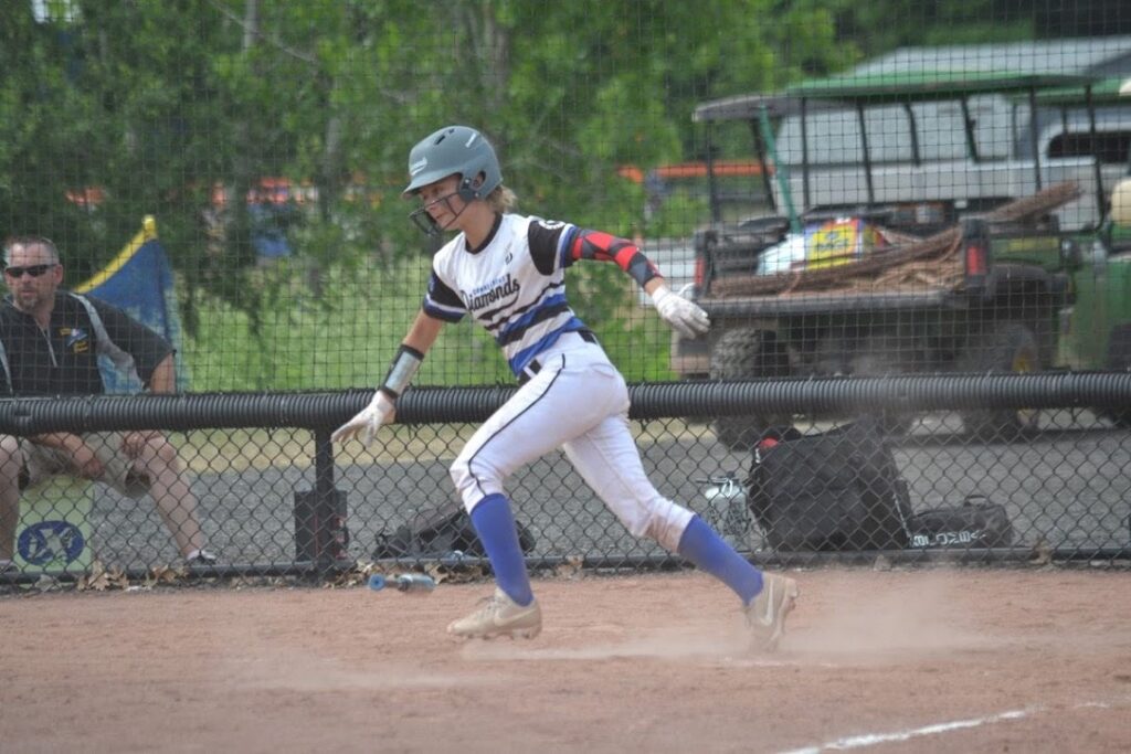 Diamond Softball Club player sprinting out of the batters box during a game